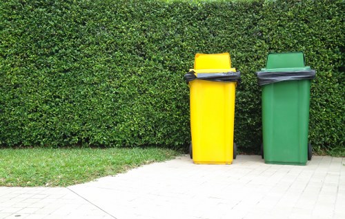 Segregated waste containers and safety signage at a commercial site